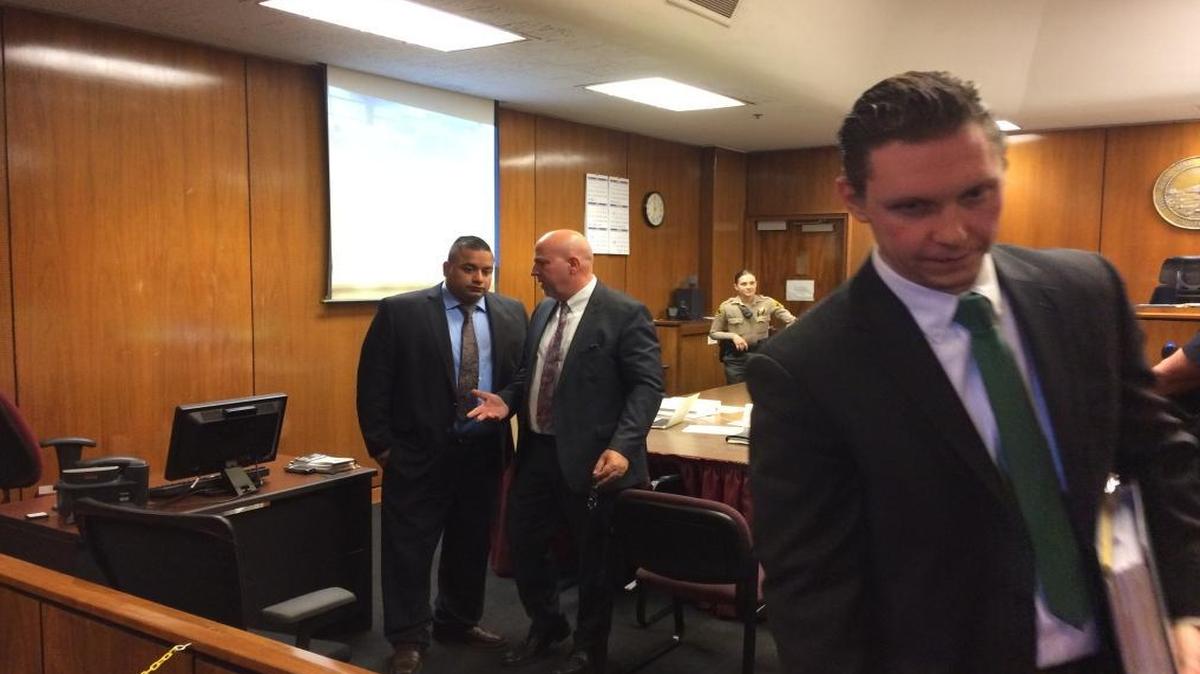 Former Fresno police officer Alfred Campos, left, leaves the courtroom with his attorneys, Mario DiSalvo, middle, and Yan Erick Shrayberman.