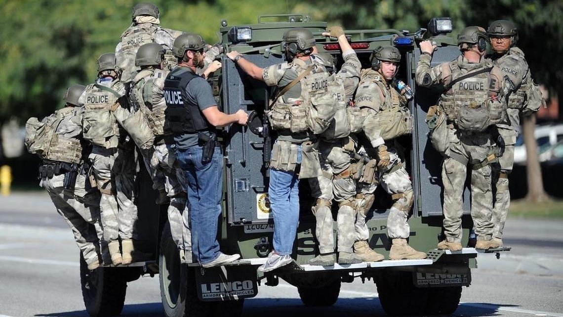 A SWAT vehicle carries police officers near the scene of a shooting in San Bernardino on Wednesday, Dec. 2, 2015. Police responded to reports of an active shooter at a social services facility.