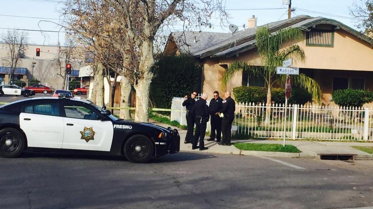 Fresno police investigate a shooting scene Friday afternoon at Madison Avenue and Mariposa Street near downtown Fresno.