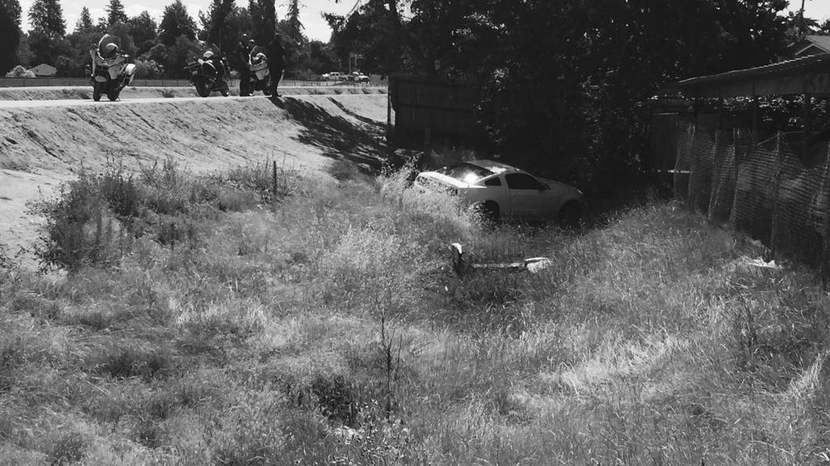 Police say suspect ditched Mustang along a Fresno canal bank.