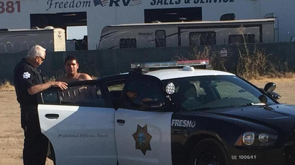 A suspect, identified as Jesus Cardenas, 19, is taken into custody at Jensen Avenue and Highway 99 after a central Fresno shooting on Friday, July 7, 2017.