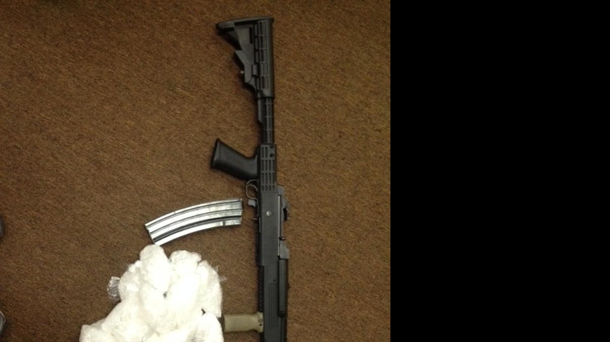 
A loaded assault rifle and packages of crystal methamphetamine that Fresno police say they recovered from suspects arrested Wednesday, July 8, 2015.
