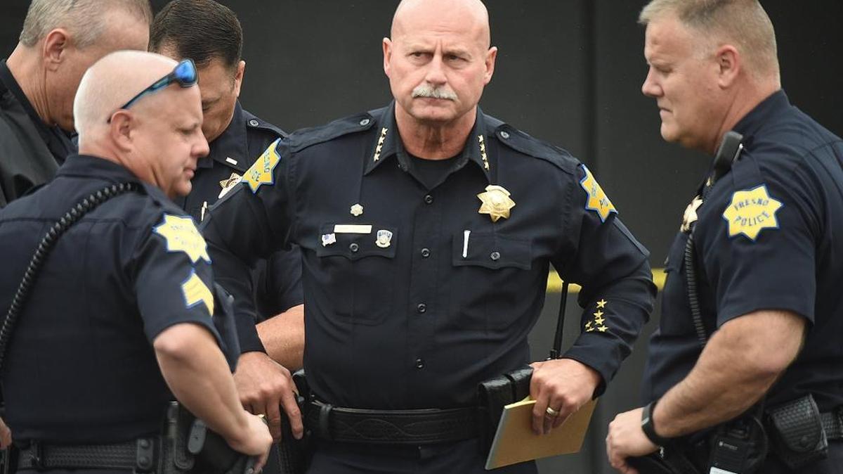 Fresno Police Chief Jerry Dyer stands with staff near the scene of the triple fatal shooting before addressing the media April 18, 2017.