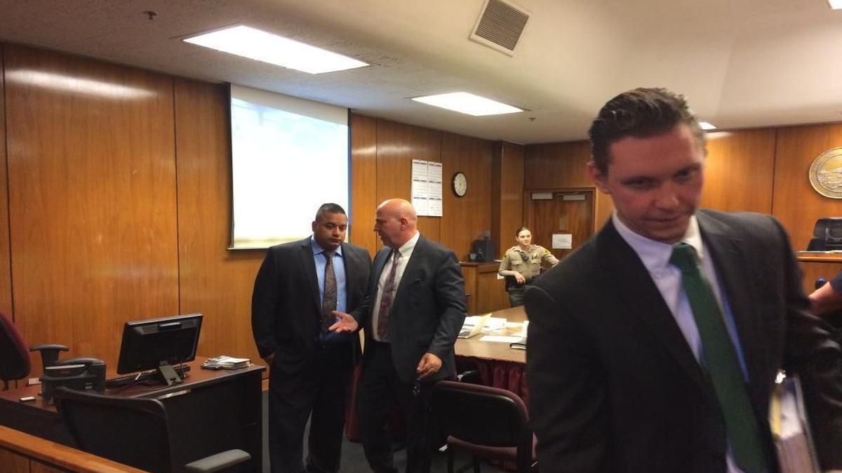 Former Fresno police officer Alfred “Al” Campos, left, talks with his attorney Mario DiSalvo while his other attorney, Yan Erick Shrayberman, leaves the courtroom. A hearing is being held to determine whether Campos should stand trial on charges of buying or receiving a stolen pickup and perjury.