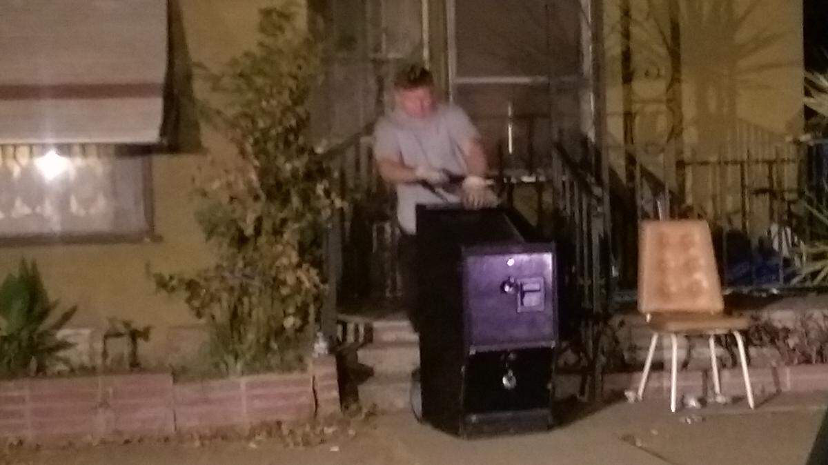 Law enforcement authorities remove a slot machine from a south-central Fresno residence where illegal gambling were reportedly being conducted, Wednesday, Aug. 26, 2015.