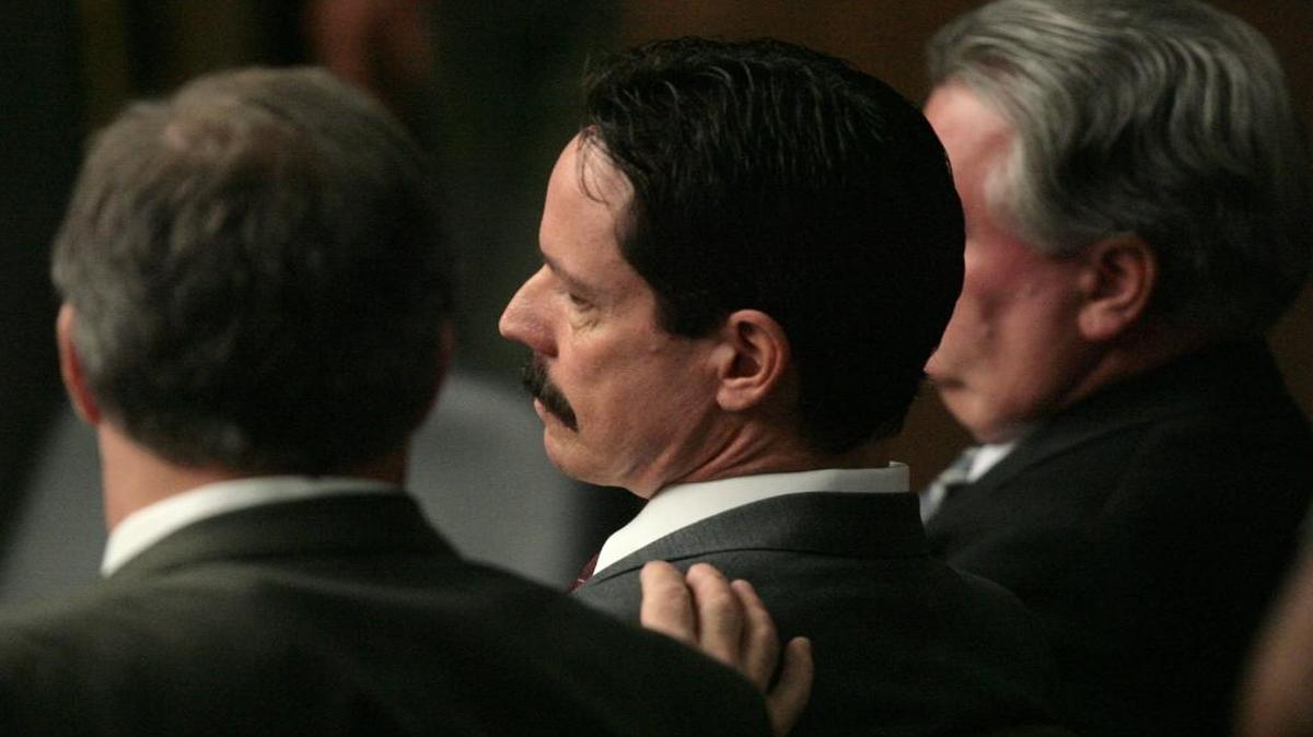 Attorney Mark Coleman lays a hand on David Hawk after Hawk was found guilty in his murder trial in August 2009.