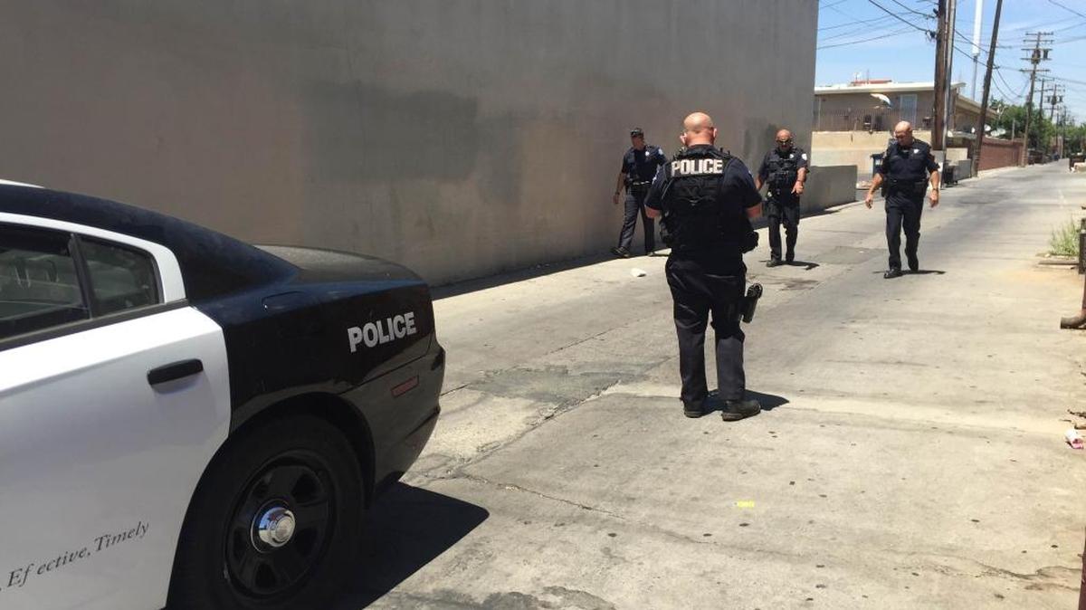 Fresno police officers investigate the scene of a stabbing in a central Fresno alley near Belmont and Van Ness avenues on Friday, July 15, 2016.