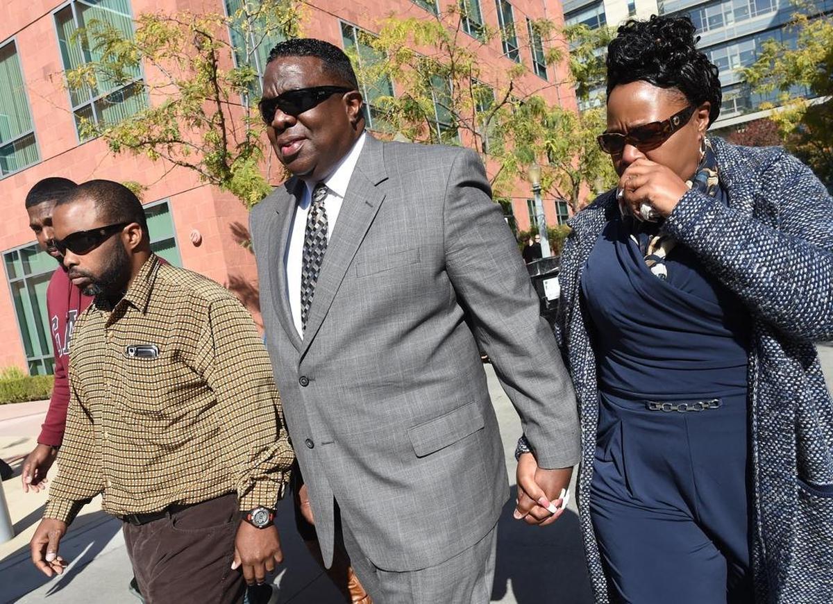 Former Fresno police Deputy Chief Keith Foster with family members at his side leaves Federal Courthouse after his sentencing, Monday afternoon, Nov. 13, 2017.
