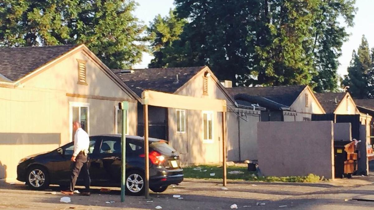 A detective searches for evidence at shooting scene in southwest Fresno.