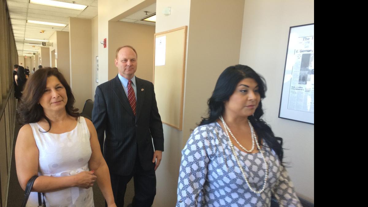 
Gail Scarber, left, her husband, Kyle Scarber, a former assistant chief of the California Highway Patrol in Fresno, and their daughter Crystal Reynoso leave a Fresno courtroom Tuesday, July 14, 2014. The Spencers and Reynoso are charged with helping their son and brother Spencer Scarber flee to Mexico in December 2012 to avoid a rape conviction. After a few months on the run, Spencer Scarber was captured and returned to Fresno, where he was sentenced to 35 years to life in prison.

