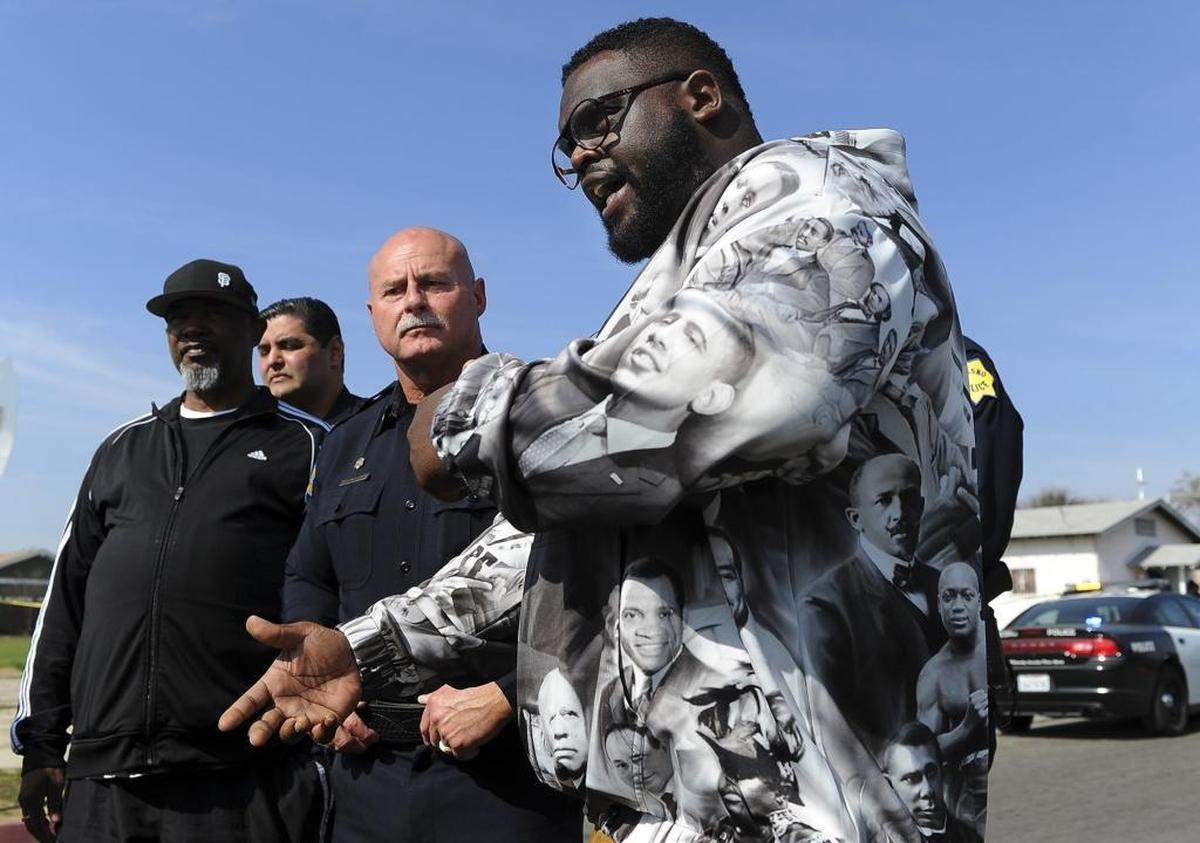 Saint Rest Baptist Church pastor DJ Criner, right, speaks out against gang violence with Fresno Police Chief Jerry Dyer standing in the middle, following the drive-by shooting of Zurich Chatman outside Pilgrim Church of God in Christ on Saturday morning, Feb. 10, 2018 in Fresno.
