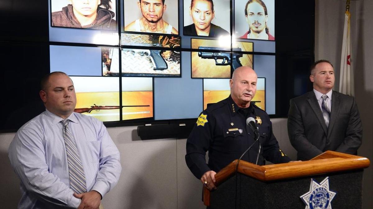 While flanked by Fresno police detectives Daniel Messick, left, and Brian Pierce, Fresno Police Chief Jerry Dyer holds a press conference to announce the arrest of several suspects in a rash of armed robberies that have occurred in the city, at the Fresno Police Department on Monday.