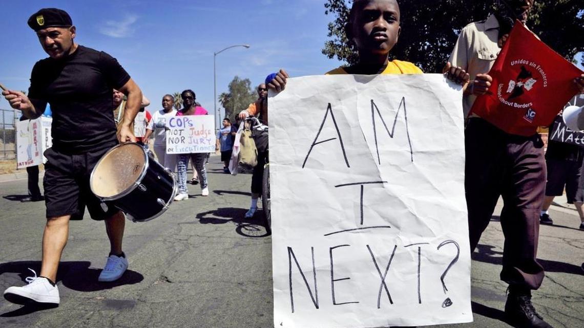 Taylon Salley, 6, carries a placard at the front of the group during a march through the New Light For New Life Church Of God neighborhood for a rally in west Fresno Saturday morning, Aug. 15, 2015. About 70 people marched and rallied calling an end to police violence and supporting the Black and Brown Lives Matter Movement. ERIC PAUL ZAMORA/THE FRESNO BEE