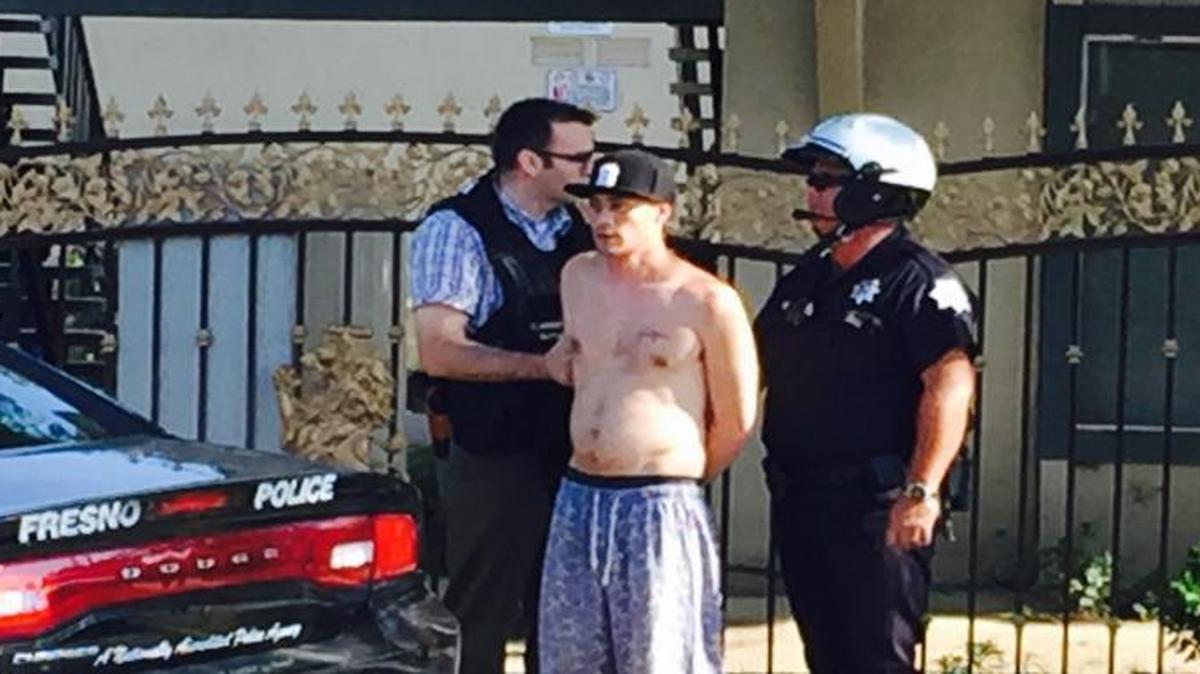 A man is detained at an east-central Fresno apartment complex Friday morning. Police say he tried to take a 40-ounce bottle of beer from a nearby convenience store.