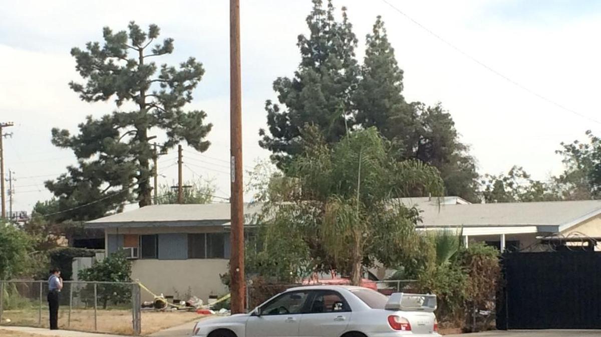 
A Fresno police officer stands in front of the northwest Fresno home where they say a 72-year-old man shot and killed his 39-year-old son. 
