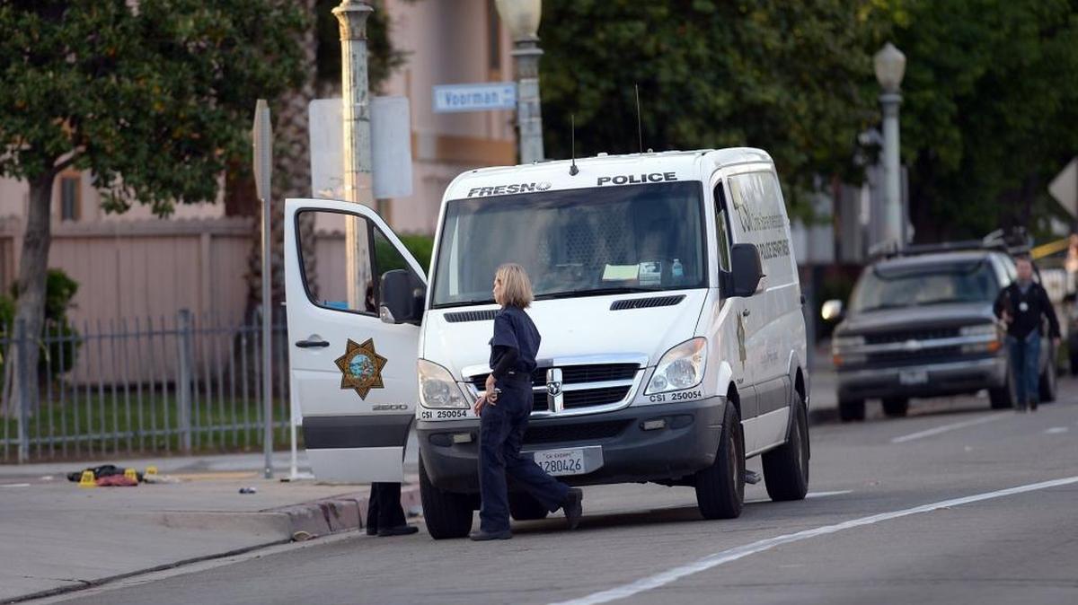 Fresno Police department personnel continue to investigate near the Catholic Charities’ Fresno Family Resource Center after three men were killed by a gun man on Tuesday morning, April 18, 2017, in Fresno. On Tuesday, Fresno police increased to $2,000 the reward offered for recovery of the gun allegedly used by suspect Kori Ali Muhammad in separate shootings that killed four people.