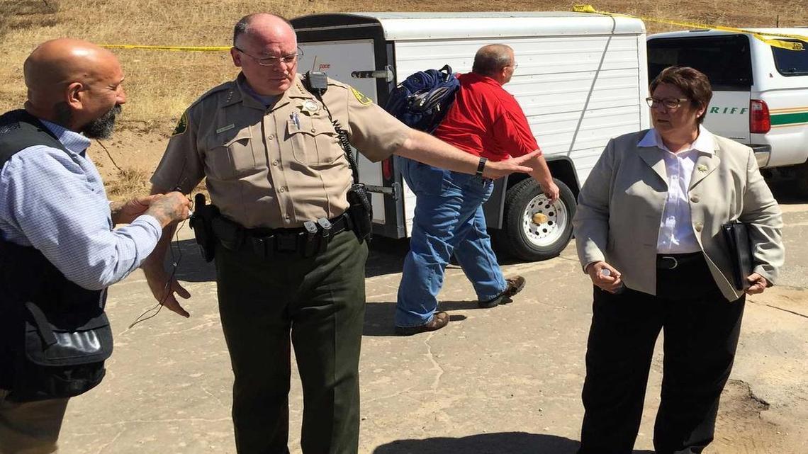 
Madera County Sheriff Jay Varney, center, and Fresno County Sheriff Margaret Mims, right, meet near the scene of an fatal shooting by a Fresno County deputy near Millerton Lake on Thursday, June 25, 2015. At a news conference, the sheriffs said the suspect pointed a rifle at deputies. 
