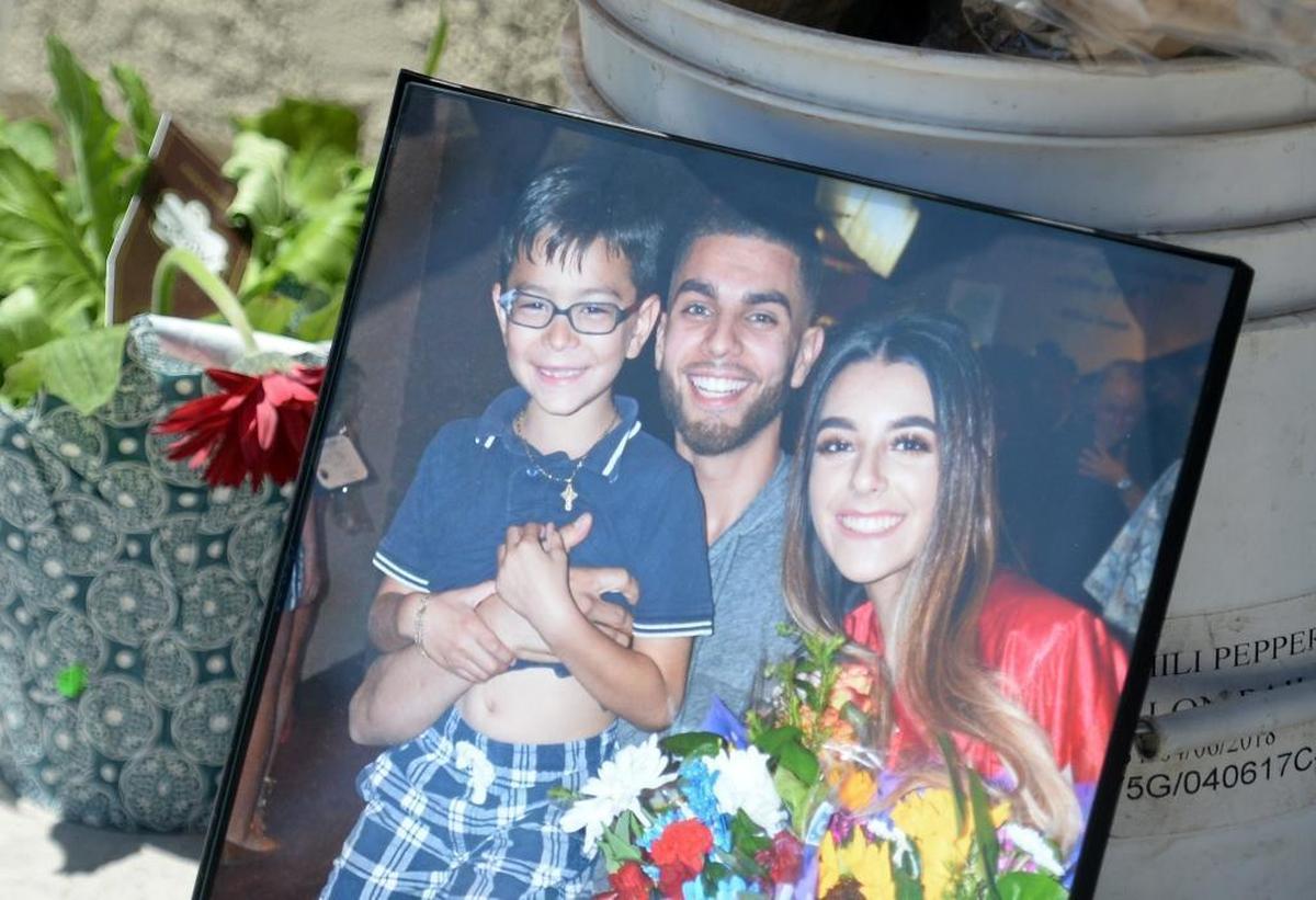 A photo shows Christopher Leon, pictured at center, at the site of his murder at DJ Outlet in southeast Fresno, on Sunday, Aug. 6, 2017.