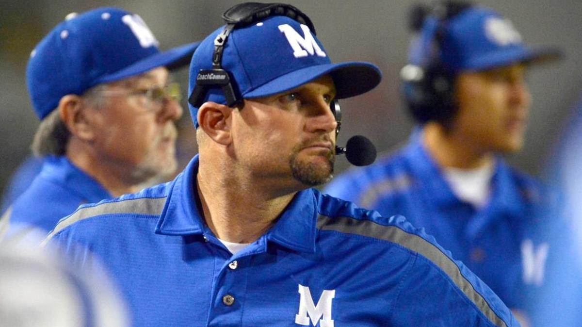 
Madera High football coach Bonner Cunnings, center. 
