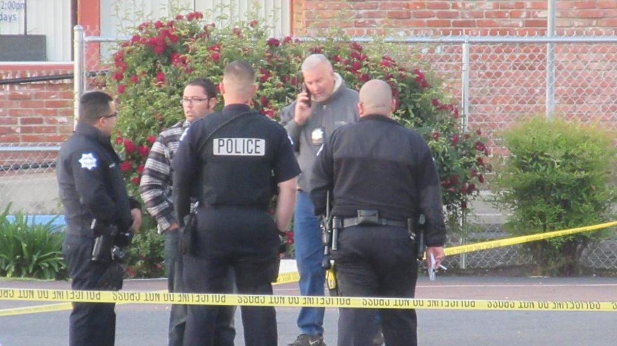 Fresno Police detectives huddle at scene of fatal shooting at Fresno Motel 6. Carl Williams, 25, of Fresno, a security guard that police said was unarmed, was shot and killed amid a dispute with a male visitor and a woman staying there.