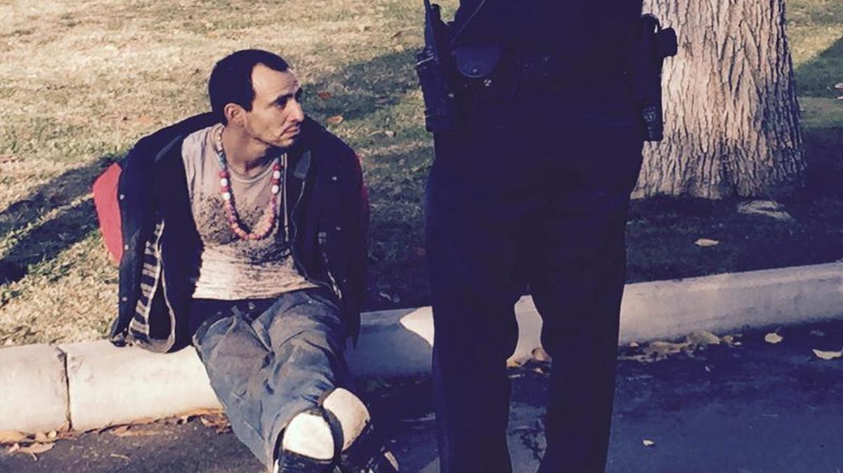 A burglary suspect is questioned by police after a Tower District break-in Wednesday, December 23, 2015. Police say a 15-year-old girl was alone in the home when the suspect came in through a dog door.