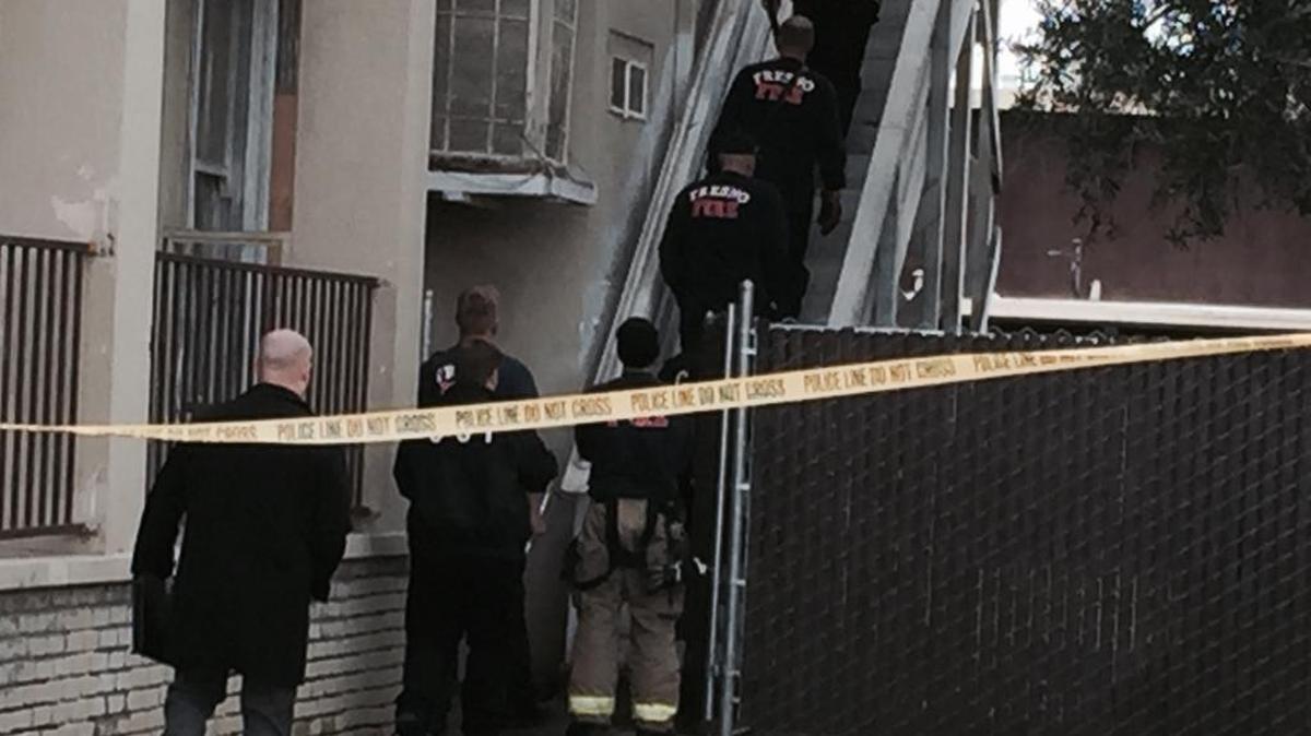 Firefighters and police at home where body was discovered.