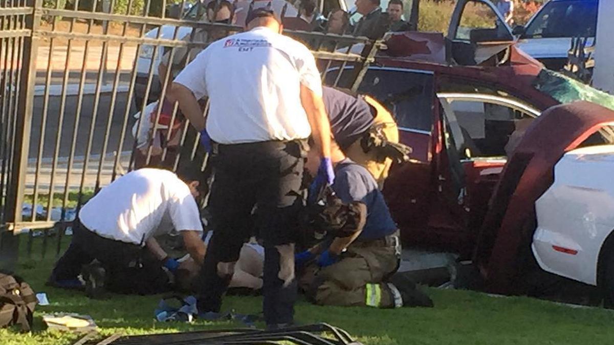 
Emergency personnel tend to a man who was driving a vehicle that crashed into a fence at Fresno Yosemite International Airport on Monday, Aug. 24, 2015. Authorities said the vehicle was being pursued by Fresno County sheriff’s deputies.
