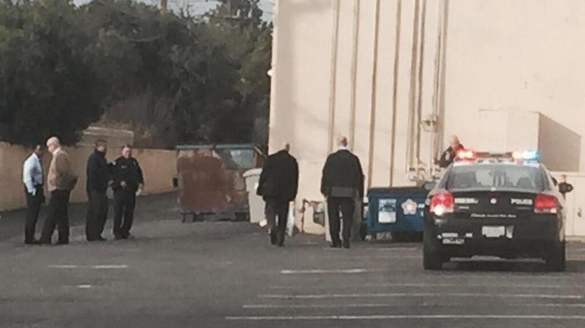 Police investigate an apparent homicide after a body was found near a dumpster at North First Street and East Barstow Avenue on Wednesday, Jan. 18, 2017.