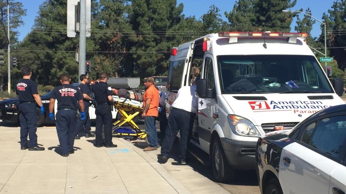 A stabbing victim is loaded into an ambulance Monday afternoon in central Fresno.