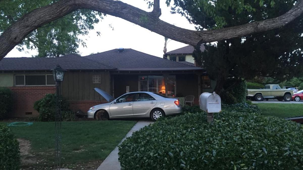 A vehicle crashed in the front yard of an Old Fig Garden home after Fresno police called off a chase involving possible suspects connected to shootings in the Tower District on Tuesday, April 12, 2016.