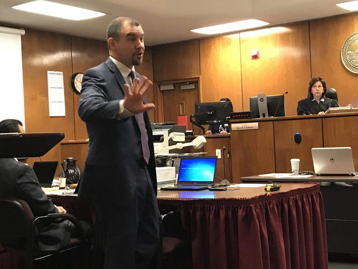 In opening statements of a trial,  prosecutor Brian Hutchins explains to a Fresno Superior Court jury on April 10, 2018, why Lorenzo Darnell Anderson, 21, is guilty of murder, even though Anderson did not fatally shoot 17-year-old Andrew Vann during a drug deal gone bad on March 31, 2016, outside a east-central Fresno church. Also in the  photograph is Judge Jane Cardoza.
