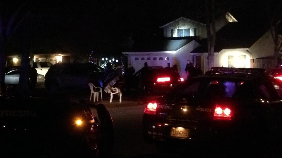 Fresno Police form a perimeter around a home west of Highway 99 on Sunday night after a man suspected of committing an armed commercial robbery earlier in the day barricaded himself inside.