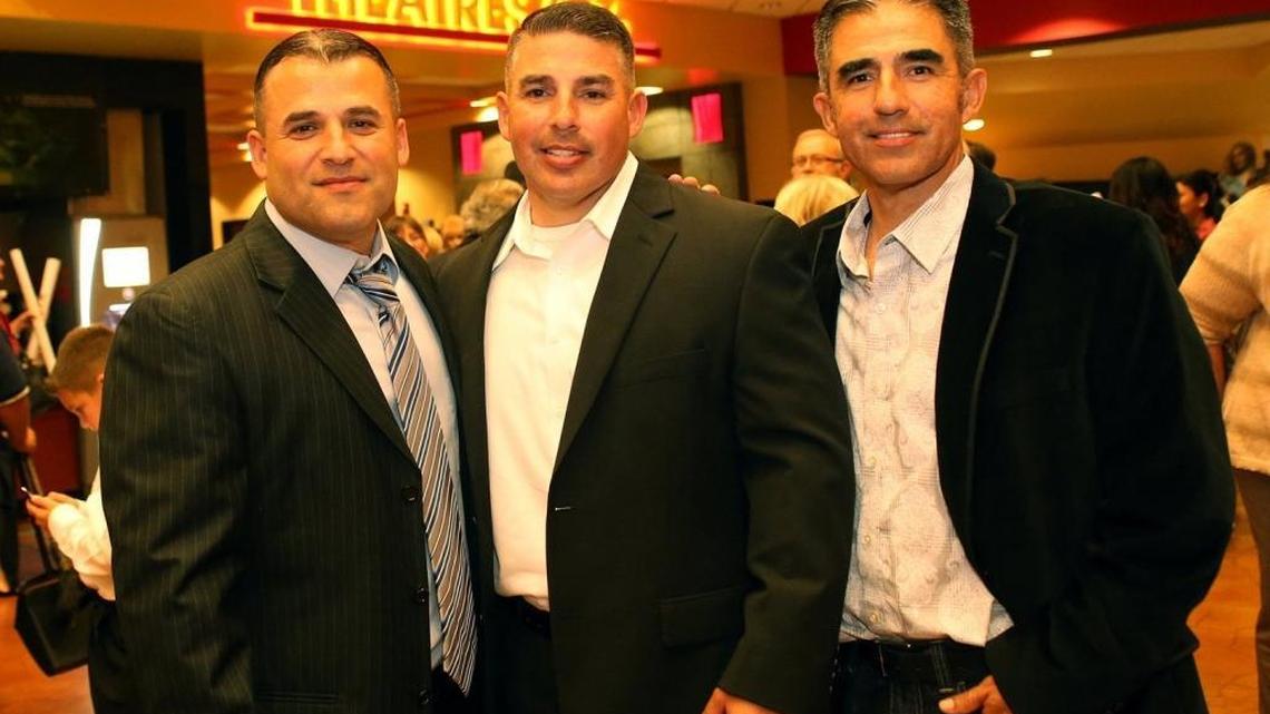 Damacio Diaz, center, poses with his older brothers, all former McFarland High School cross country runners who were on the 1987 state-championship team. Also pictured is Danny Diaz, left, and David Diaz, right, at the premier of “McFarland USA” at Maya Cinemas in Bakersfield on Feb. 15, 2015.
