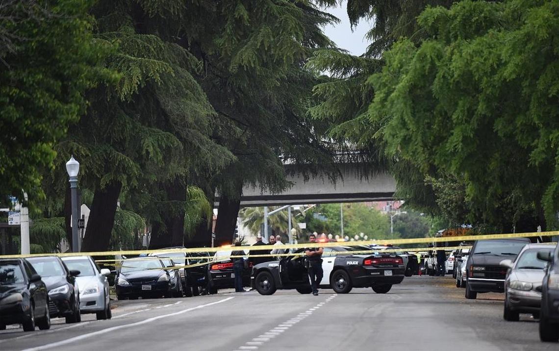 In the tranquil setting of Fulton Street transformed as the scene of the triple shooting, Fresno police stand by during their investigation, Tuesday morning, April 18, 2017.