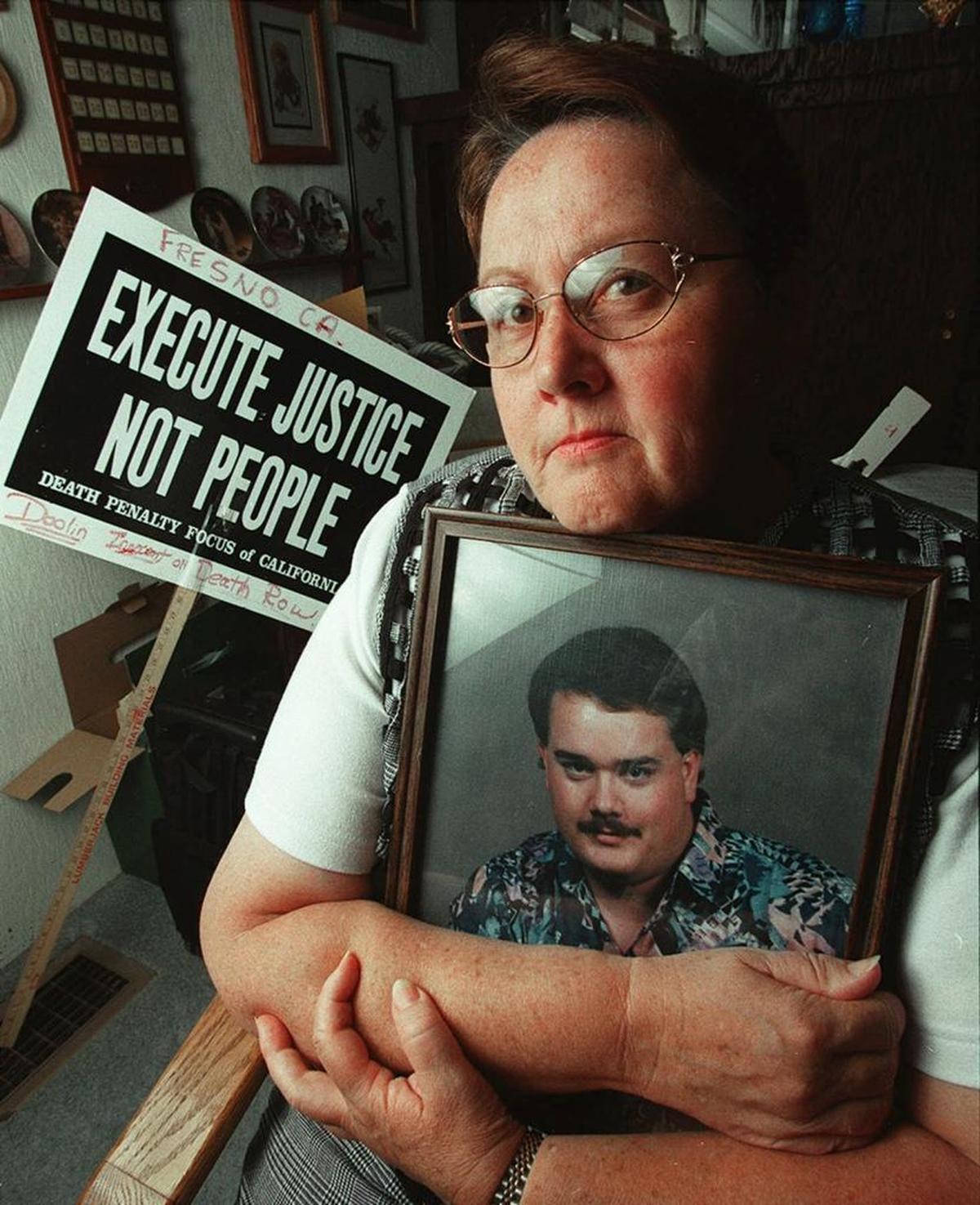 In this 2000 photograph, Donna Larsen holds a photo of her son Keith Zon Doolin, who has been on California’s death row after being convicted in 1996 of shooting six sex workers in Fresno. Larsen is appearing in French documentary that will air Tuesday on French television.