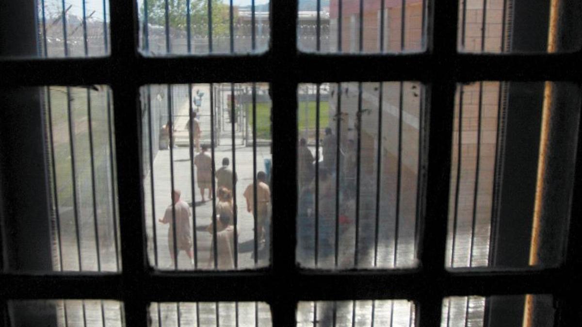 Patients from a ward at Atascadero State Hospital take a smoke break in the ward courtyard.