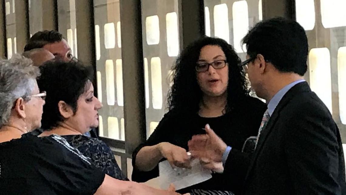 Jovannee Reynolds, 29,of Fresno, second from the right, talks with her lawyer, Curtis Sok, after a judge sentenced her on Friday, July 14, 2017, to probation in connection with the September 2010 death of 1-month-old Mikayla Tabin.