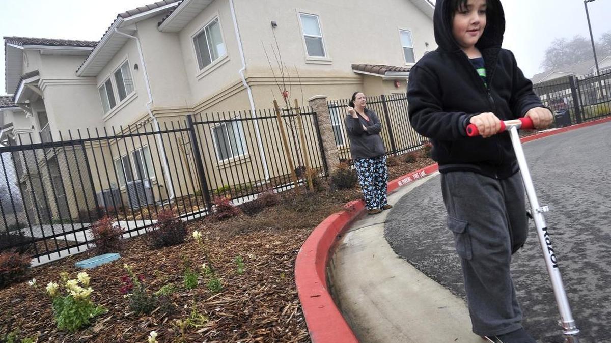 6-year-old Evan Lorigo goes for a spin Friday morning, Jan. 8, 2016 on his scooter as his mom, Tammy Webb, grabs a smoke in front of Sanger Crossing Apartments, where they live. Webb said the shooting death of a young man on New Year’s Day happened in front of her apartment where she said she saw the victim laying on the stairs. She said she feels safer now that certain tenants are gone, and security guards are in place.