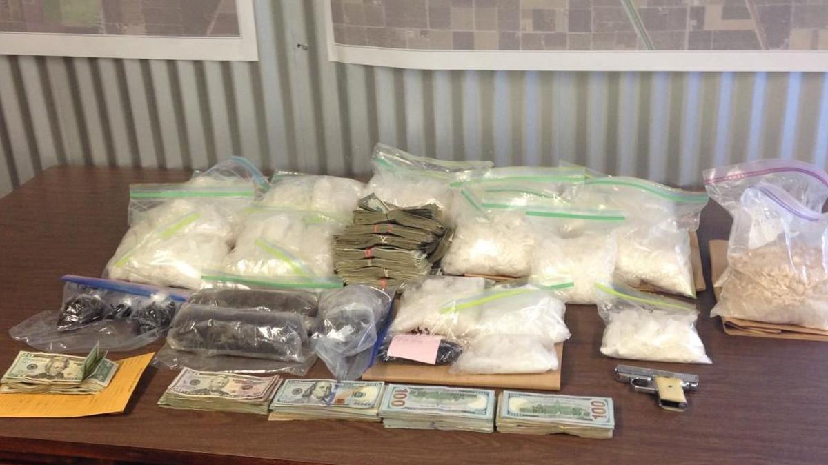 
Drugs, cash and guns found during a gang sweep Friday at an Earlimart home.
