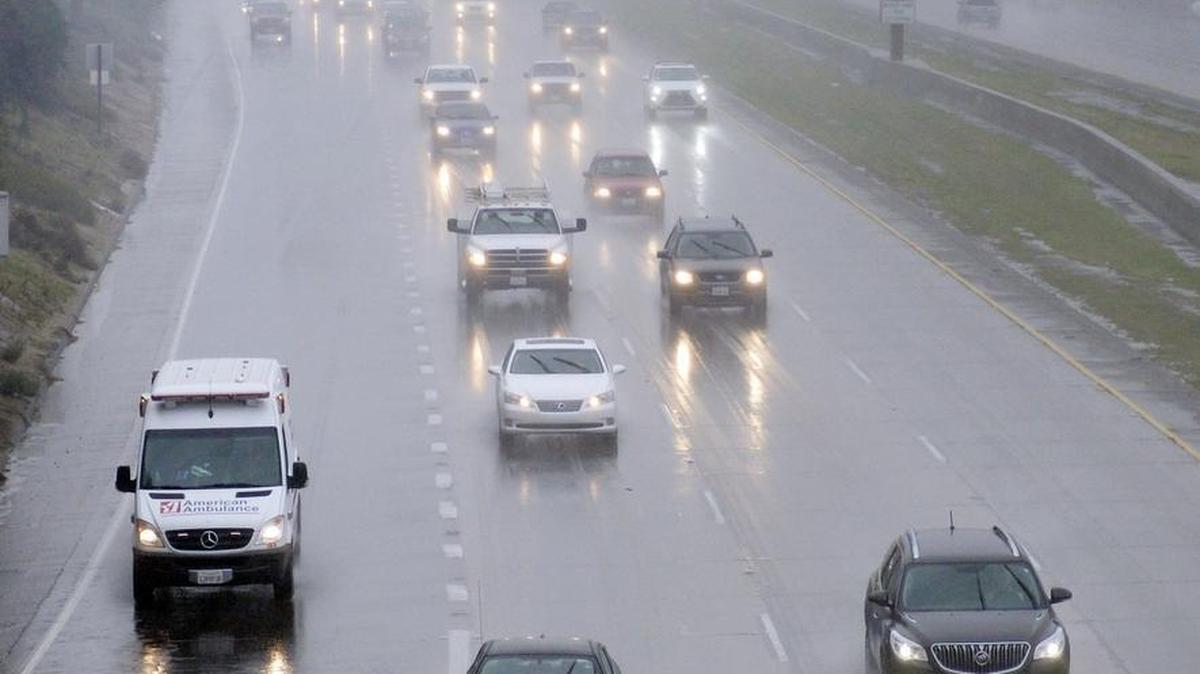 A misty rain covers the sky as cars drive south on Highway 41 near the 180 interchange.