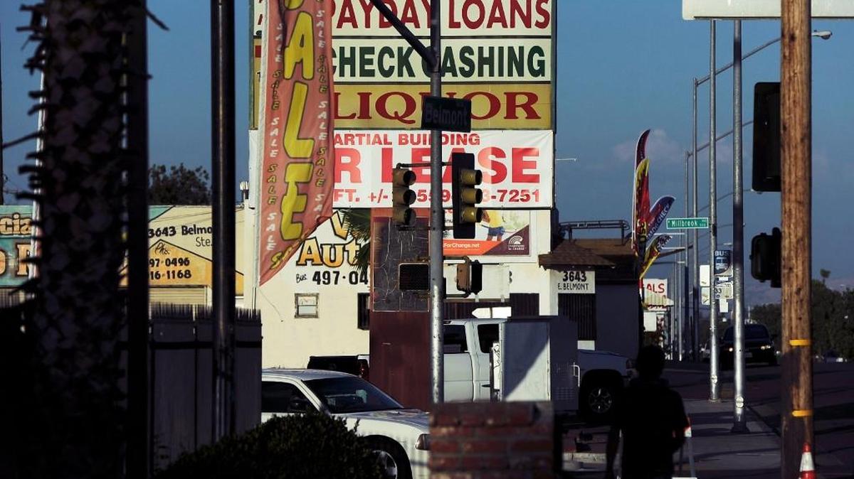 Liquor stores, check-cashing businesses, used-car lots, automotive shops and others merchants compete for attention along Belmont Avenue near Millbrook Avenue in east-central Fresno in this July 2017 file photo.