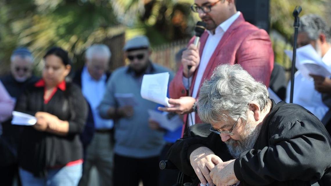 Poverello House founder Mike McGarvin bows his head as Poverello executive director Cruz Avila concludes a memorial service for Fresno area homeless on Feb. 14, 2017.