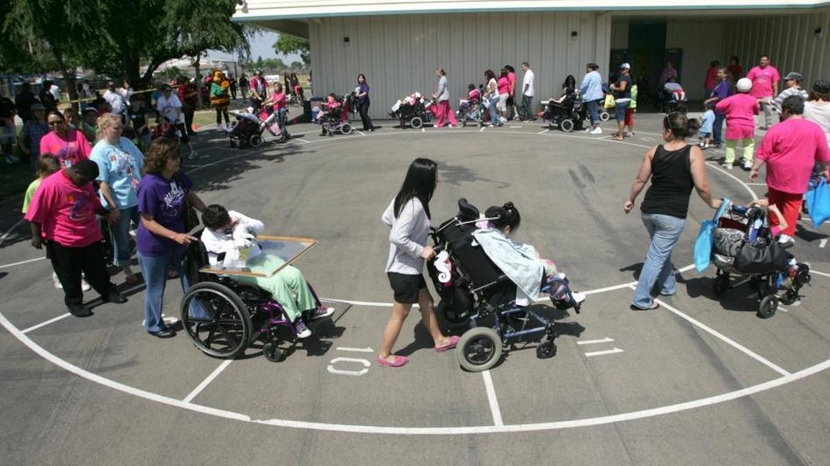 Kids are pushed in their wheelchairs during a cake walk at Addicott Elementary in this file photo.