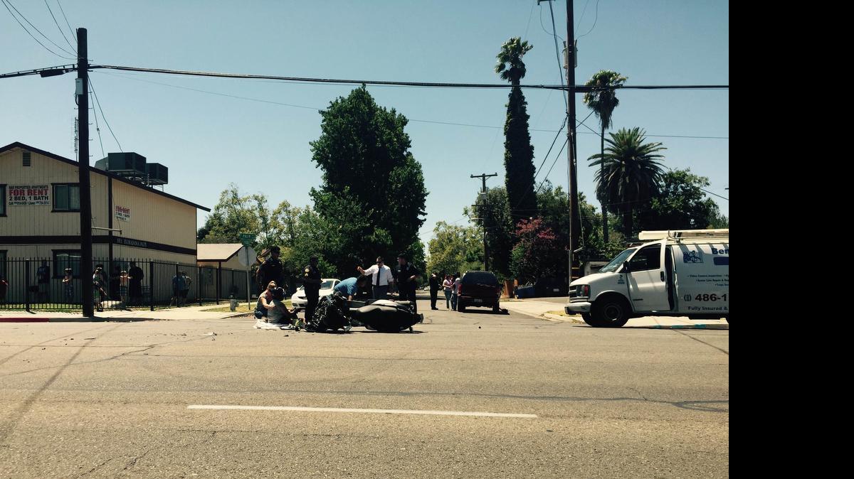 
Police and emergency worker aid motorcyclist after crash in central Fresno
