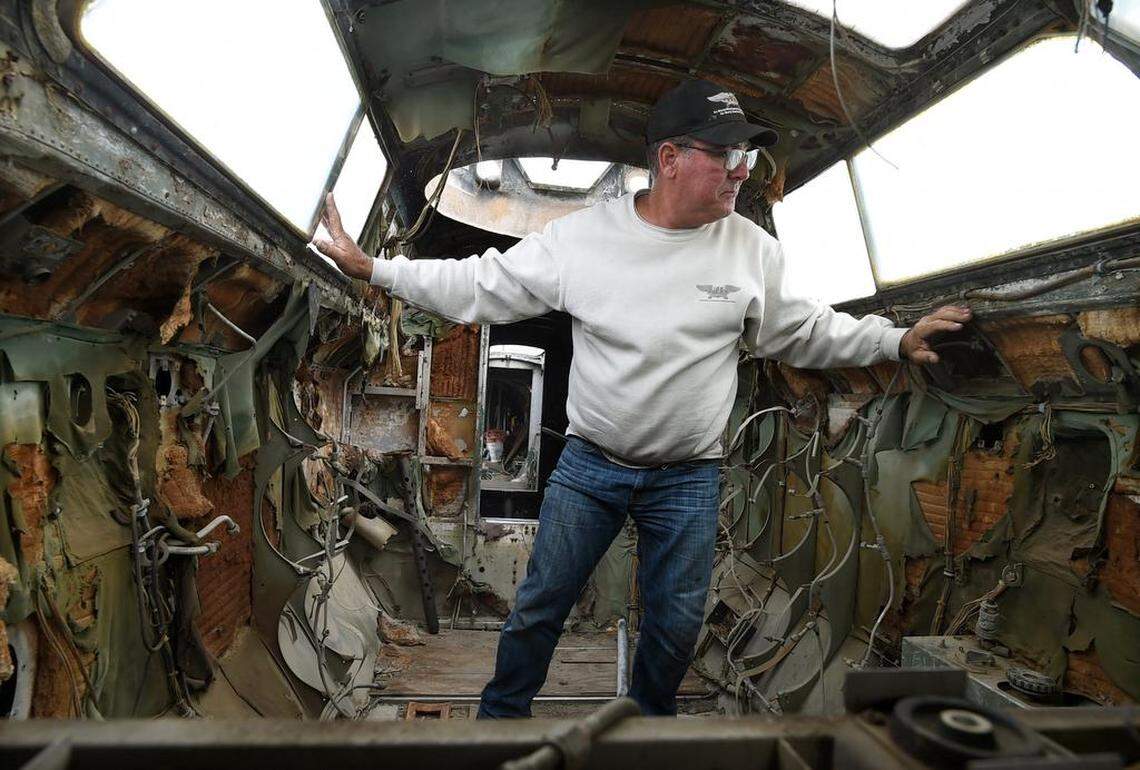 B-17 Archaeology director Greg Stathatos observes work being done outside the B-17 "Preston's Pride," from the ragged interior, Wednesday, April 18, 2018. He's overseeing work being done to bring the old warbird's appearance back to days of it served as part of Atomic testing during the post-World War II period.