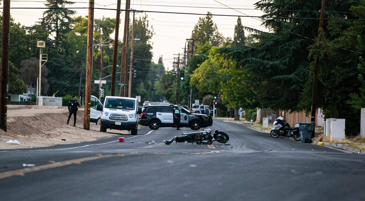 A motorcycle remains in the street after a collision with van that left the motorcyclist in critical condition Thursday July 22, 2021, in central Fresno, California.