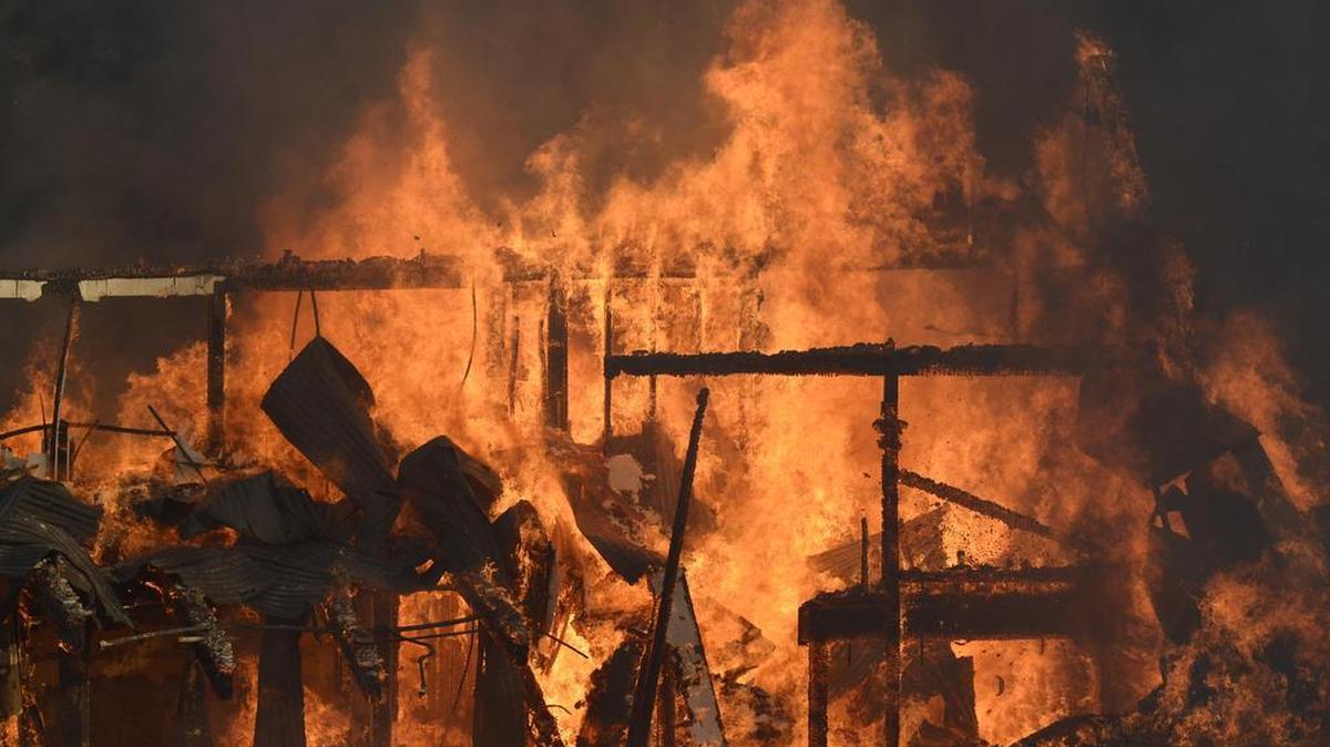 A structure along Highway 41 burns at the edge of Oakhurst during the Junction Fire in 2014. Madera County is poised to add fire stations, firefighters and firefighting volunteers if residents approve a 1-cent sales tax increase on March 7.