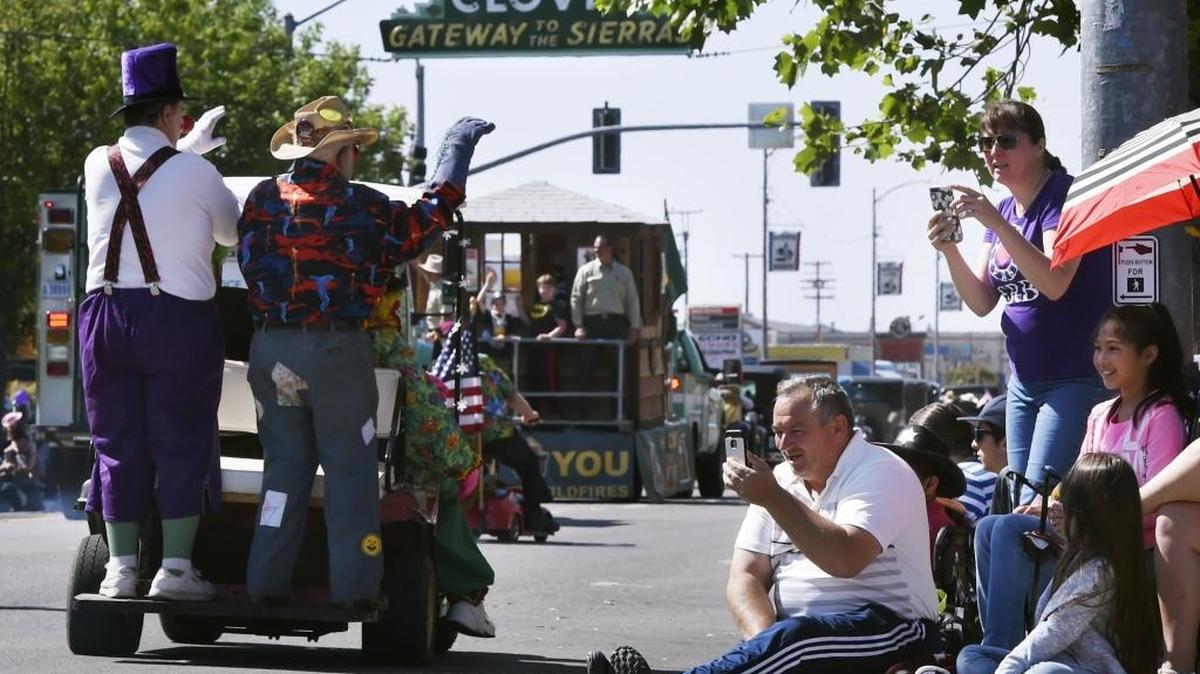 Spectators watch and photograph clowns from the corner of Clovis and Fourth avenues during the 103rd Clovis Rodeo Parade held Saturday, April 29, 2017 in Clovis, Calif. Thousands lined the streets along the 2.5-mile route.