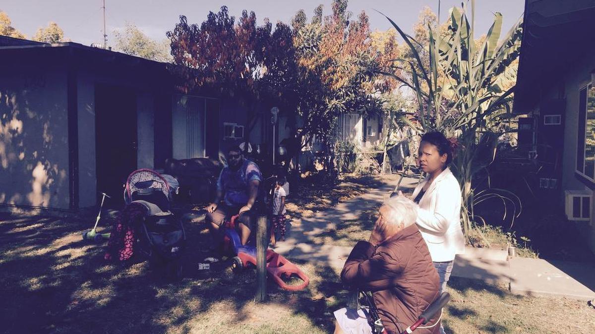Rigoberto De Lamora, Tauv Soy and Noi Khounesy sit outside their apartments Tuesday morning, Nov. 24, 2015. They live in the central Fresno complex that’s been without hot water and heat for about two weeks because of broken gas lines.