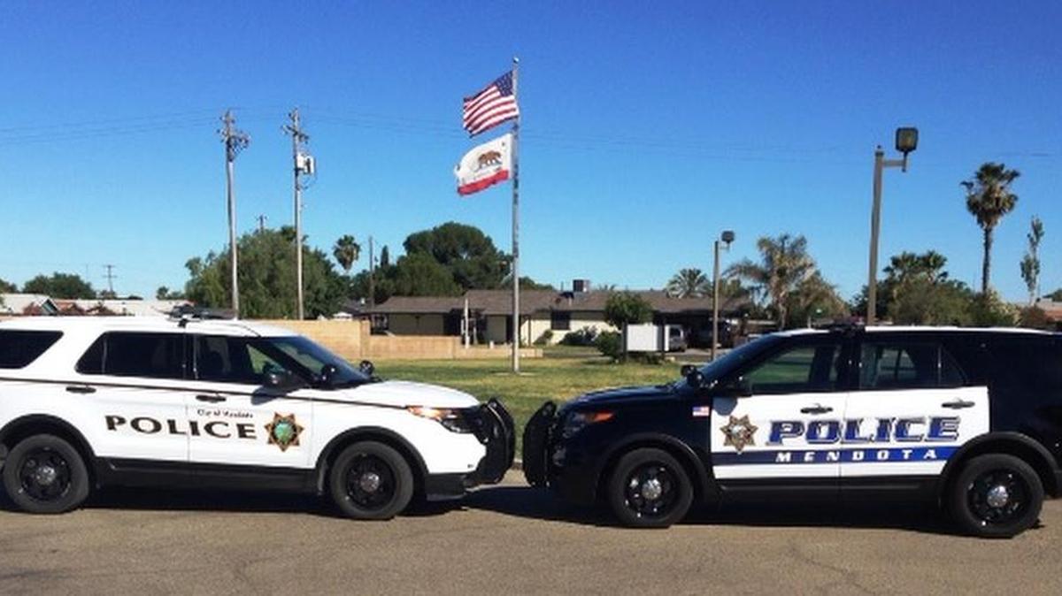 One of the original all-white Mendota patrol cars sits beside one of the the updated, redesigned police cars soon to be cruising through neighborhoods.